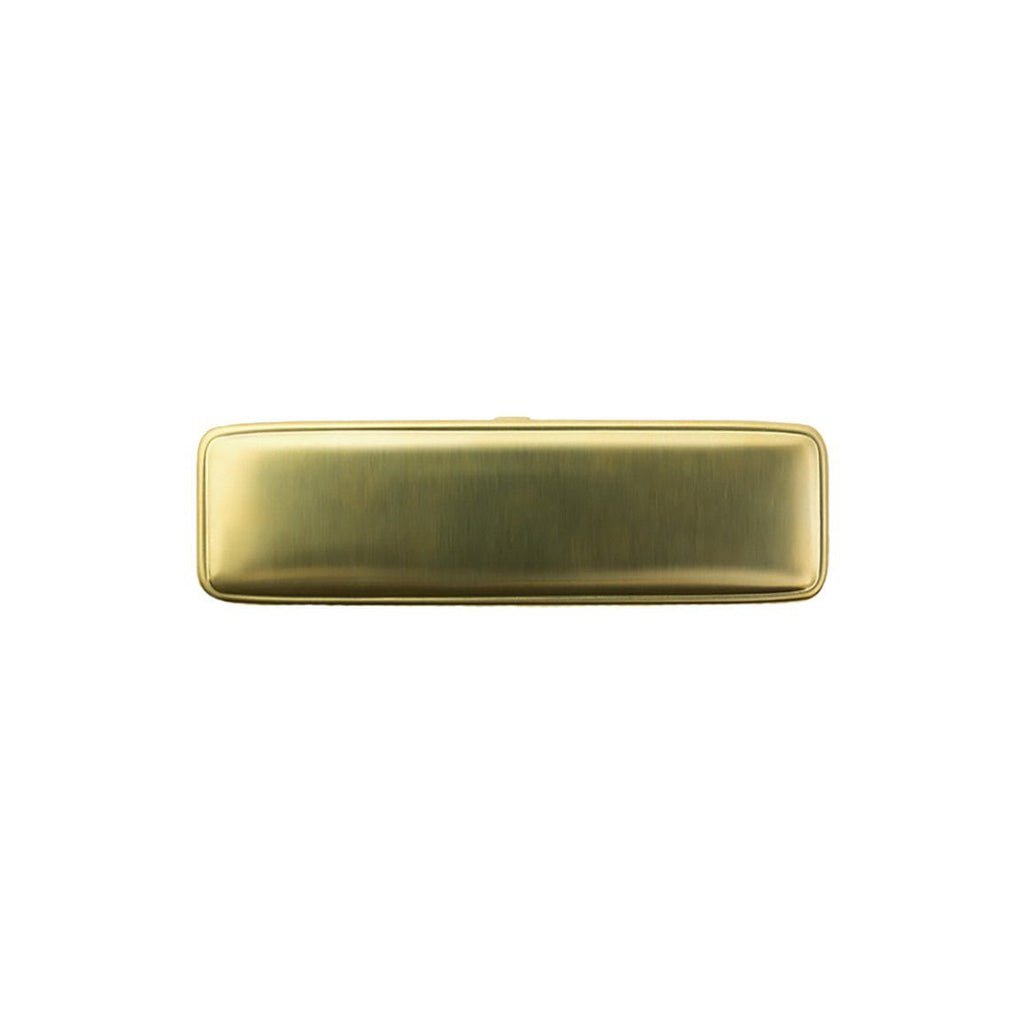 Brass pen case on white background