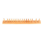 A wooden brush rack with pegs on white background