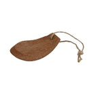 Brown coconut husk pan scraper on rope loop on white background