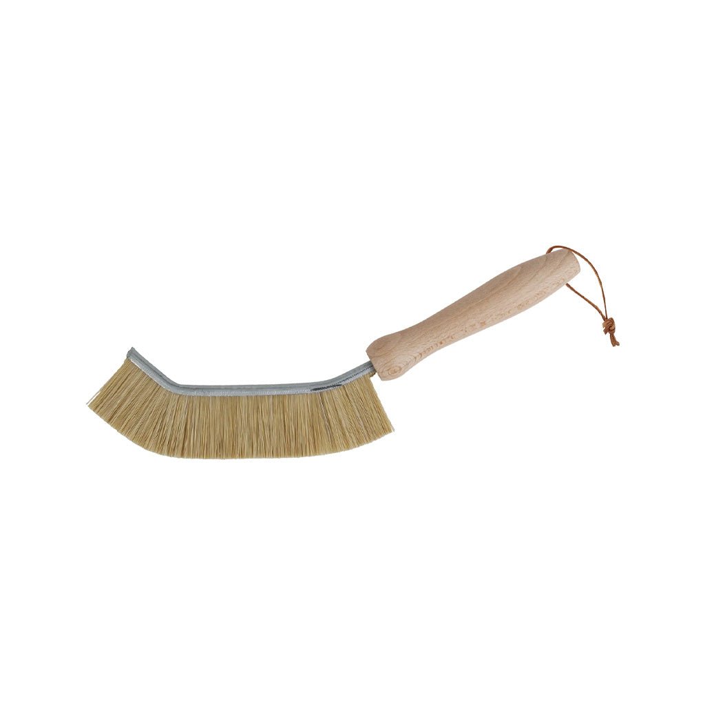 Angled wooden edge brush with natural bristles and leather loop on white background