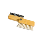 Small wooden laptop brush open with one row or black bristles and one with light-colored bristles on white background