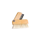 Small wooden laptop brush half-open with one row or black bristles and one with light-colored bristles on white background