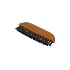 A wooden pocket clothes brush with black hog hair bristles on white background