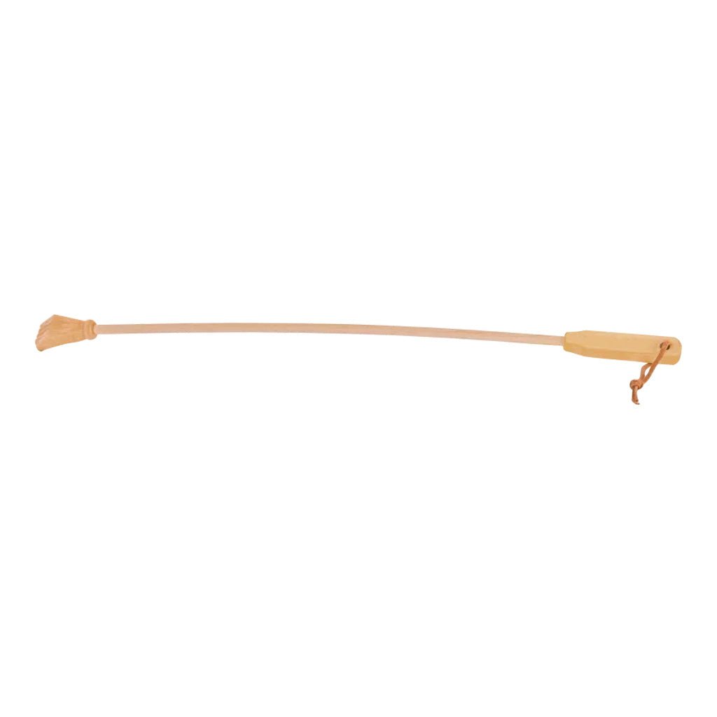 A long slender wooden backscratcher with carved hand on one side and leather loop on handle on white background