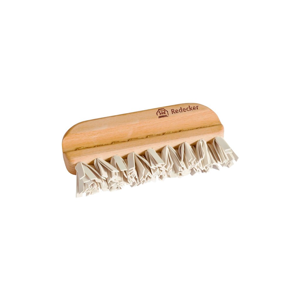 Wooden lint brush with rubber bristles on white background