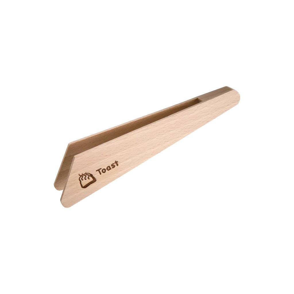 A pair of light natural wood toast tongs with the word 'Toast' and a small bread icon engraved on one end, shown on a plain white background.