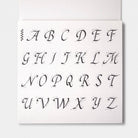 A calligraphy guide sheet with uppercase letters and guide lines on light background