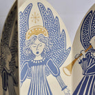 Close-up of blue angel illustration with gold foil details.