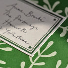 Close-up of sticky label with green accents.