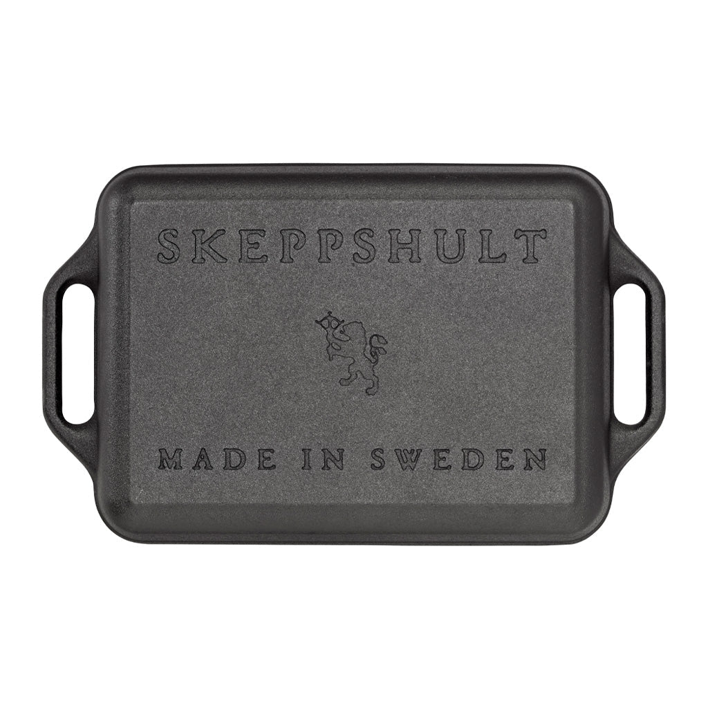 Black rectangular cast iron baking dish with handles and Skeppshult branding on a white background 