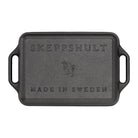 Black rectangular cast iron baking dish with handles and Skeppshult branding on a white background 