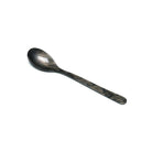 A grayish brown cereal spoon on a white background.