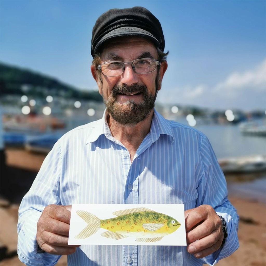 Person holding card with yellow fish