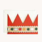 Back of red crown-shaped card with a colorful star pattern on a white background