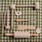 Set of wooden kitchen utensils on a green and white checkered tablecloth