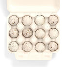 Open carton of chocolate speckled eggs.