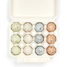 Open carton of chocolate eggs with speckled shells.