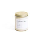 Candle jar labeled 'Christmas Tree' with a gold lid on a white background