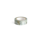 A roll of washi tape with a muted green and gray typographic pattern.