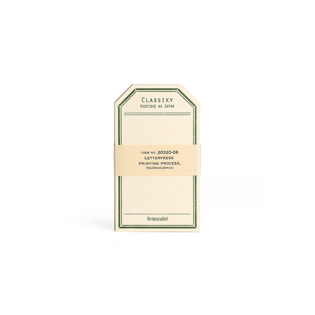 Tag-shaped cream letterpress stationery cards with a green border.