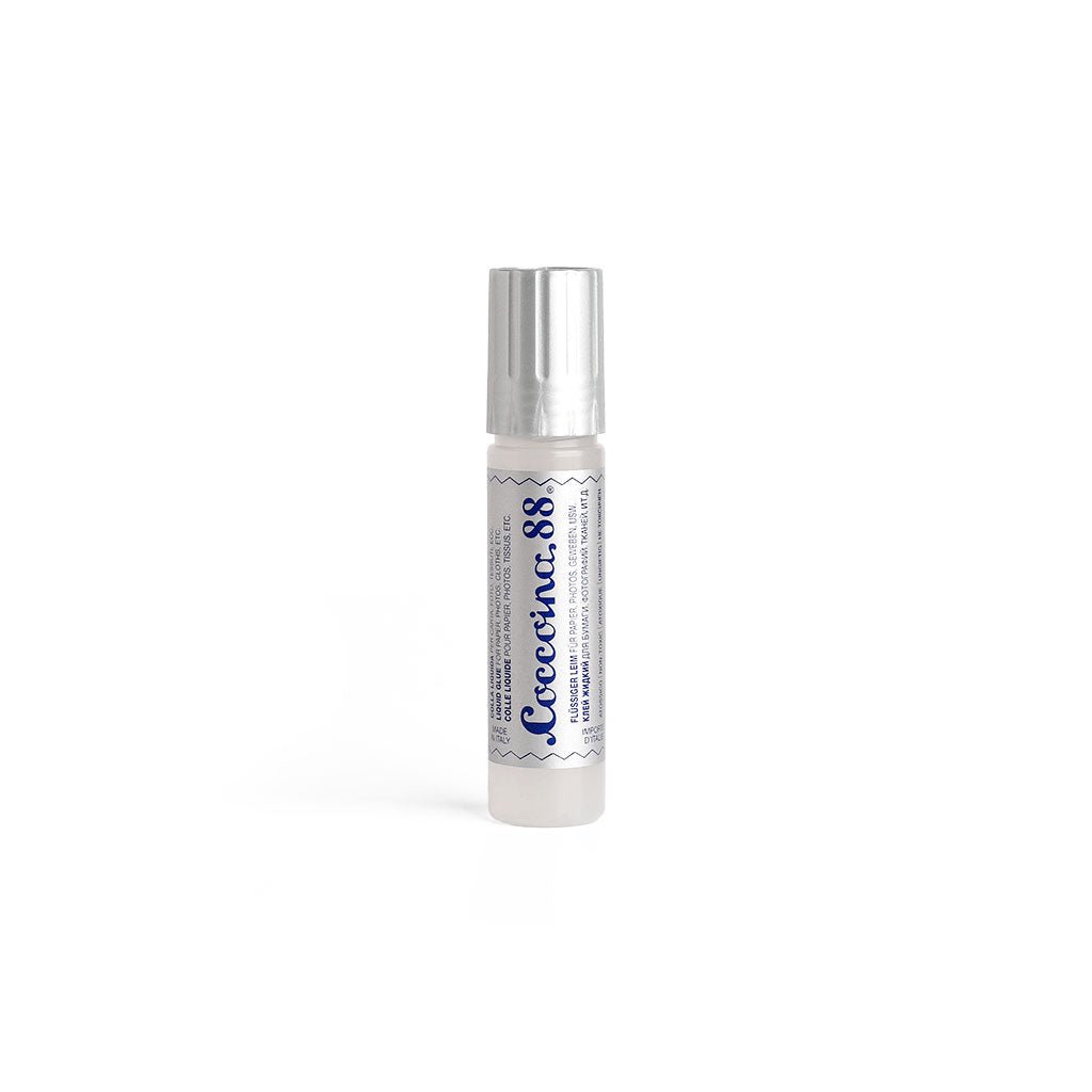Coccoina 88 liquid glue bottle with rubber tip applicator on white background