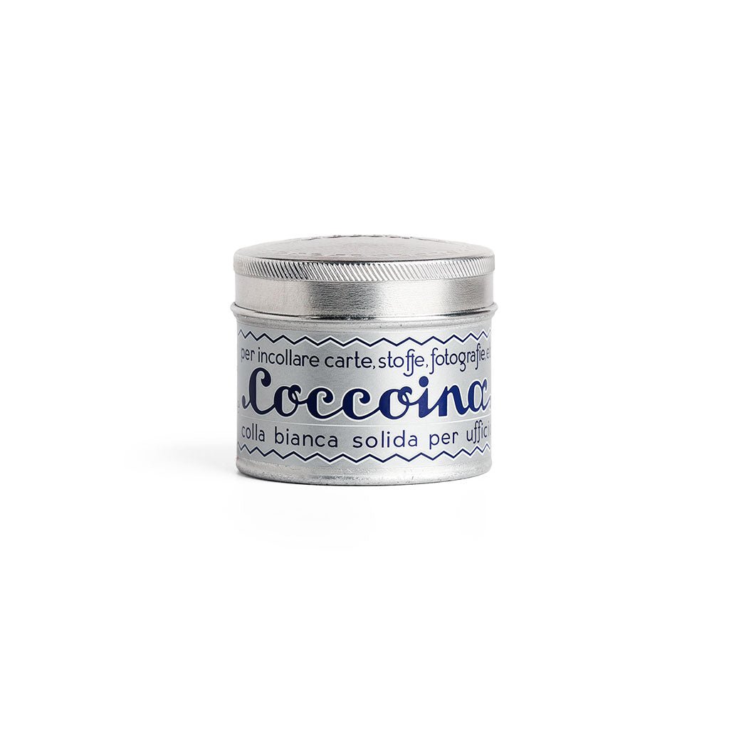 Tin of Coccoina adhesive paste on white background