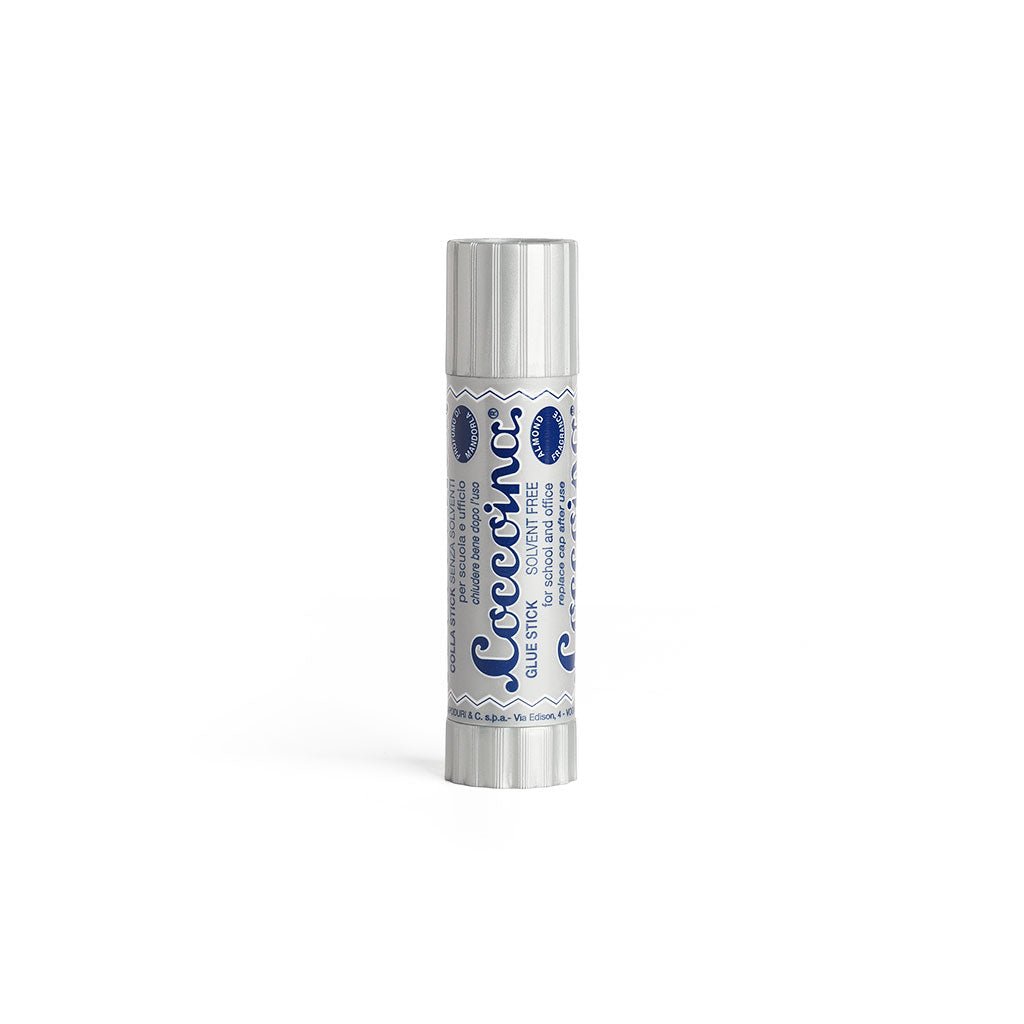 Silver and navy tube of Coccoina Adhesive on a white background