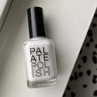 Bottle of white coconut nail polish on white background