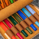 Set of colorful Kaweco pens in a brown case on a textured surface
