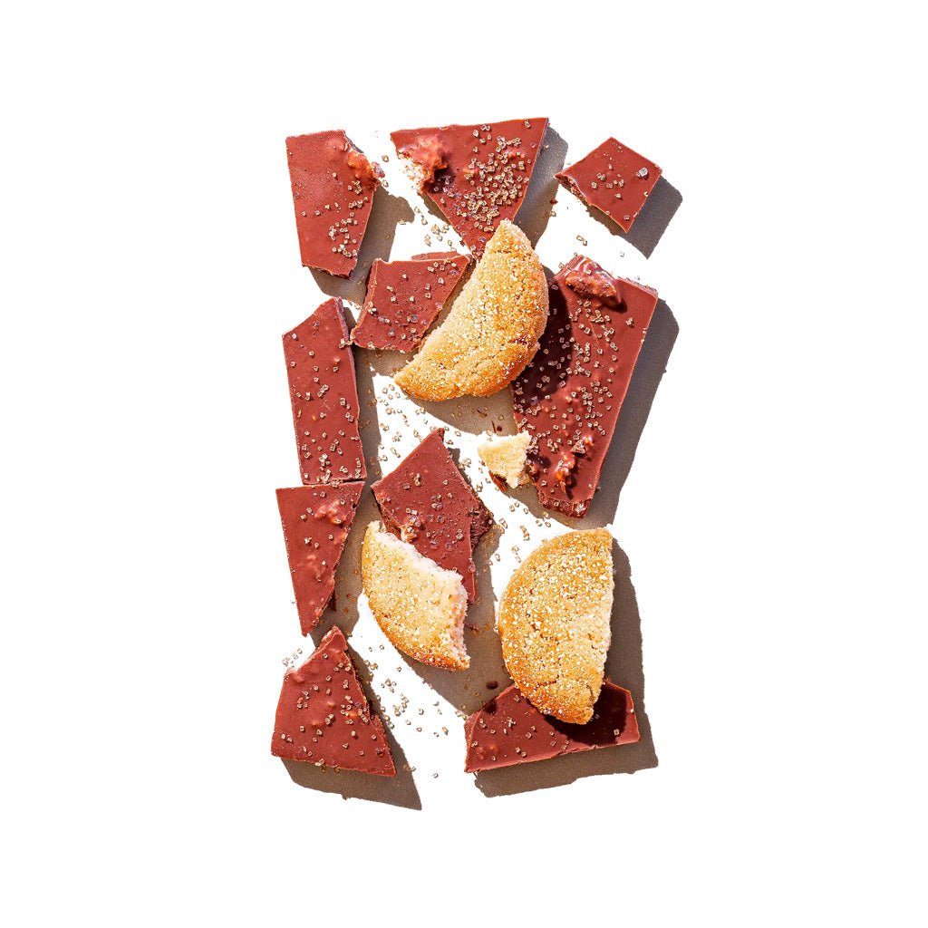 Broken sugar cookie chocolate bar with cookie pieces on top.