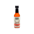A bottle of Craic Sauce Mill City Red hot sauce on a plain white background.