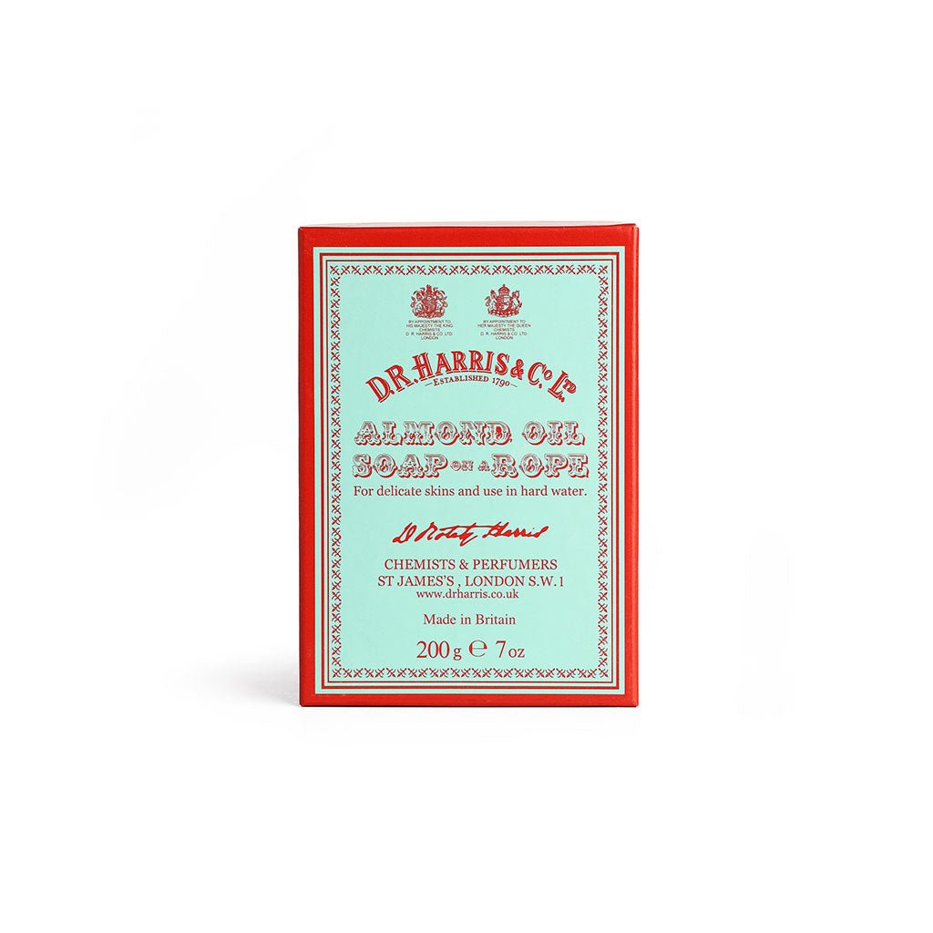 Box of almond oil soap on a rope on a white background