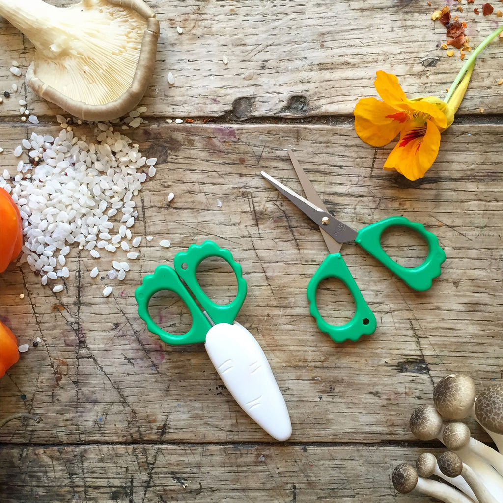 Two daikon mini snip scissors on wooden background