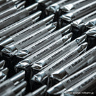 Close-up of multiple silver foil-wrapped Rollbahn mini noteboos, arranged in neat rows with the brand name clearly printed on each package.