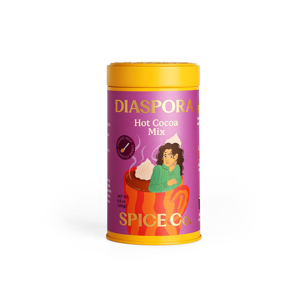 Diaspora Spice Co. Hot Cocoa Mix canister with yellow lid and illustration of a woman in a cup of cocoa.