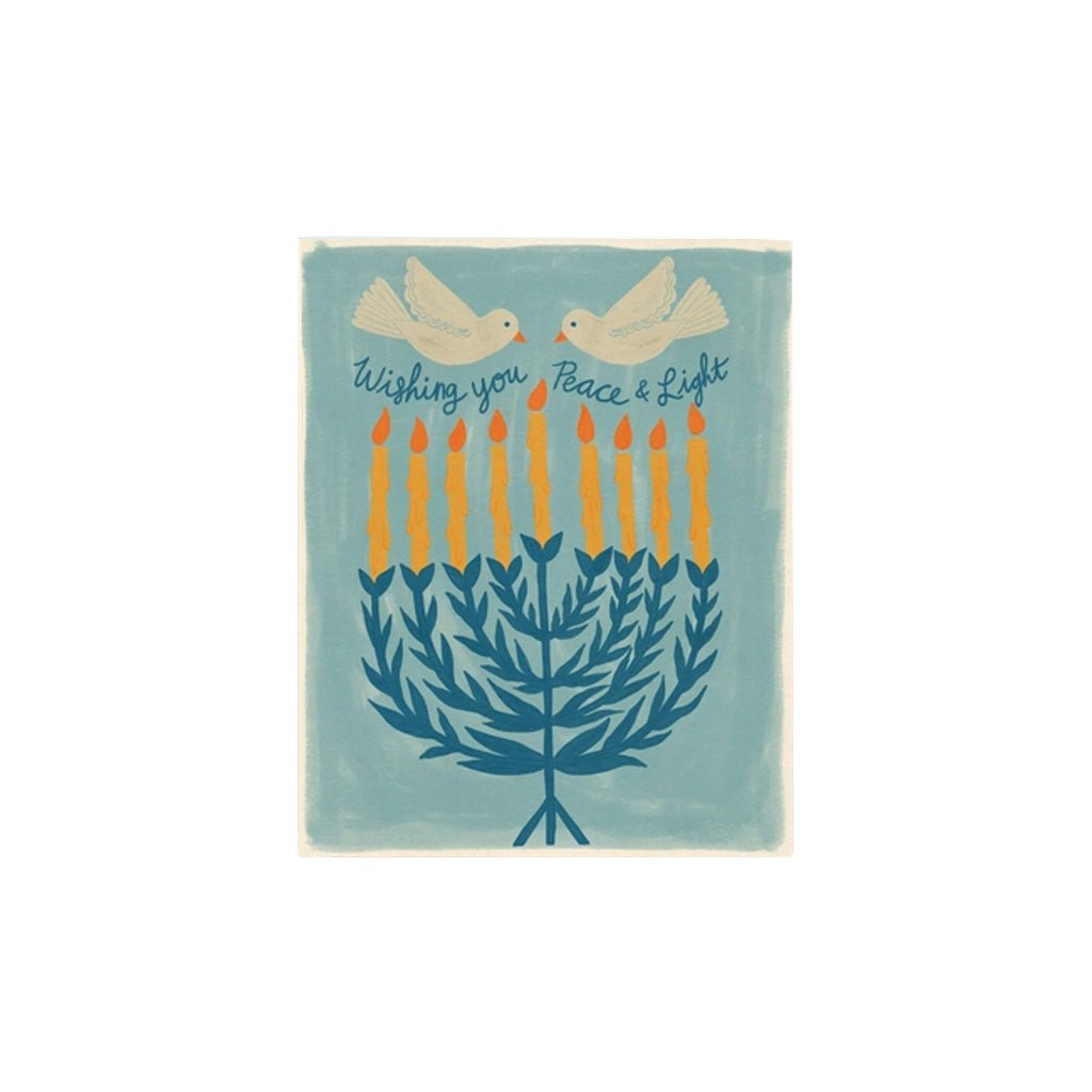A greeting card with an illustration of a leafy menorah. Two doves fly above it over the text "Wishing you peace & light".