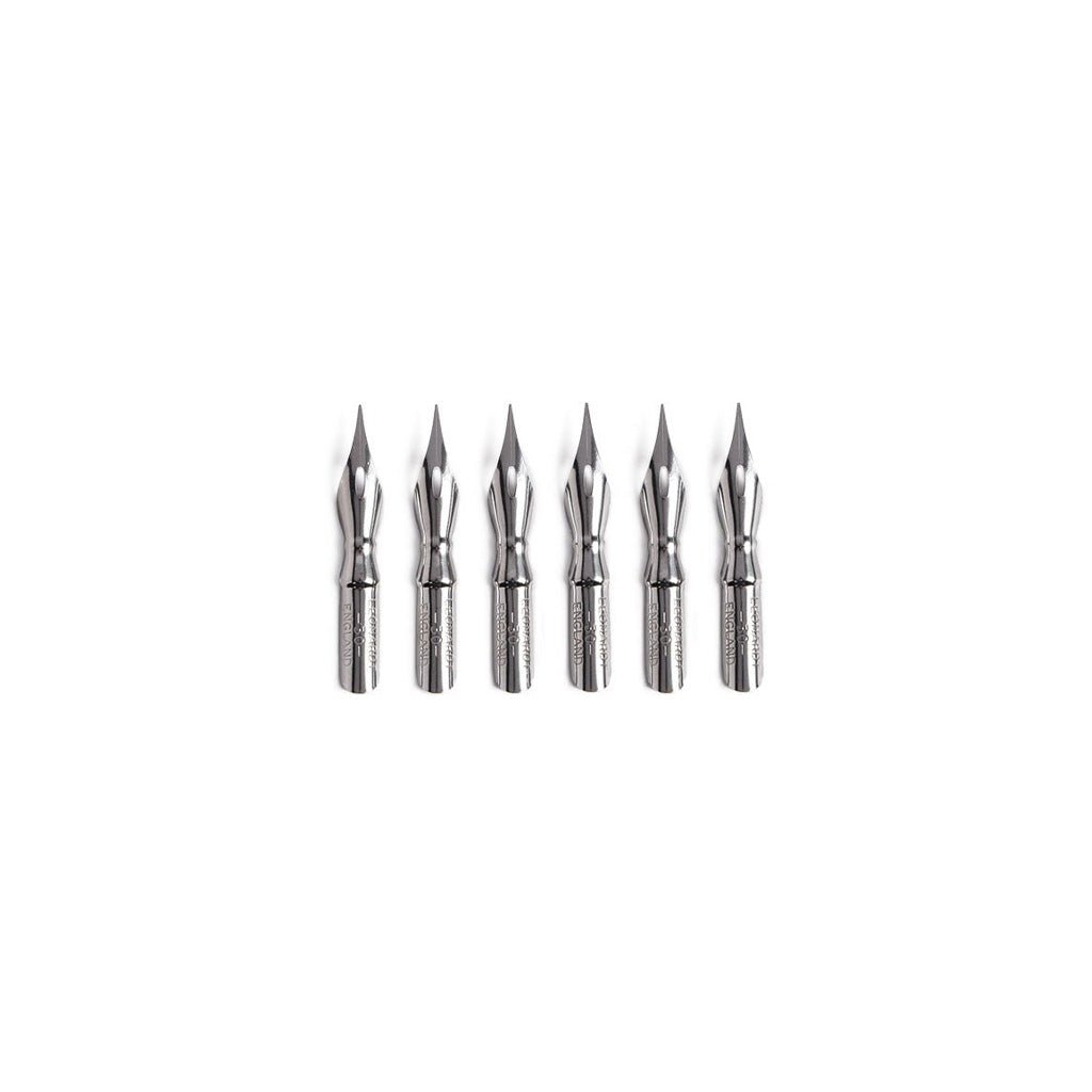 Set of six metal nibs on a white background