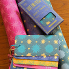 Colorful gift tags on top of rolls of wrapping paper.