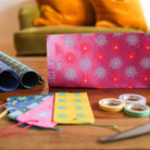 Table with gift wrapping supplies.