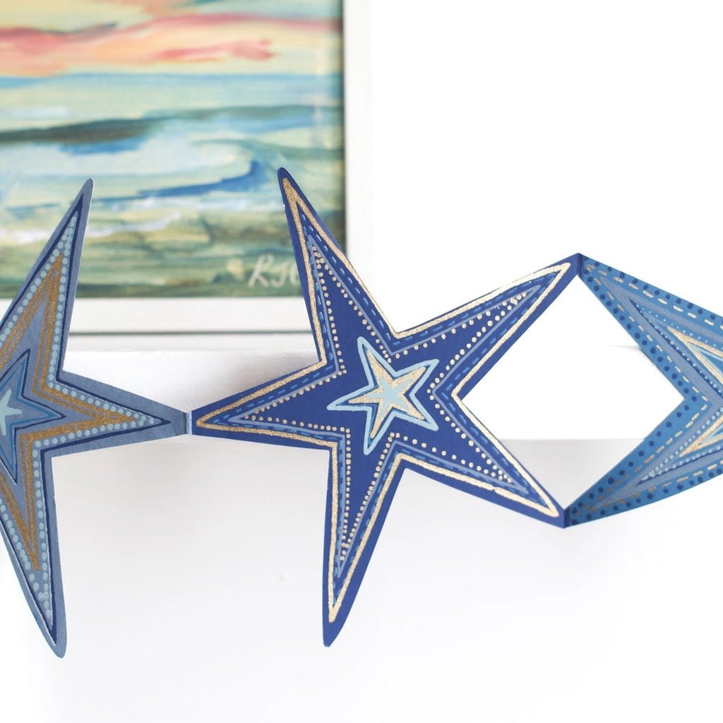 Close-up of blue paper star with metallic details.