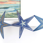 Close-up of blue paper star with metallic details.