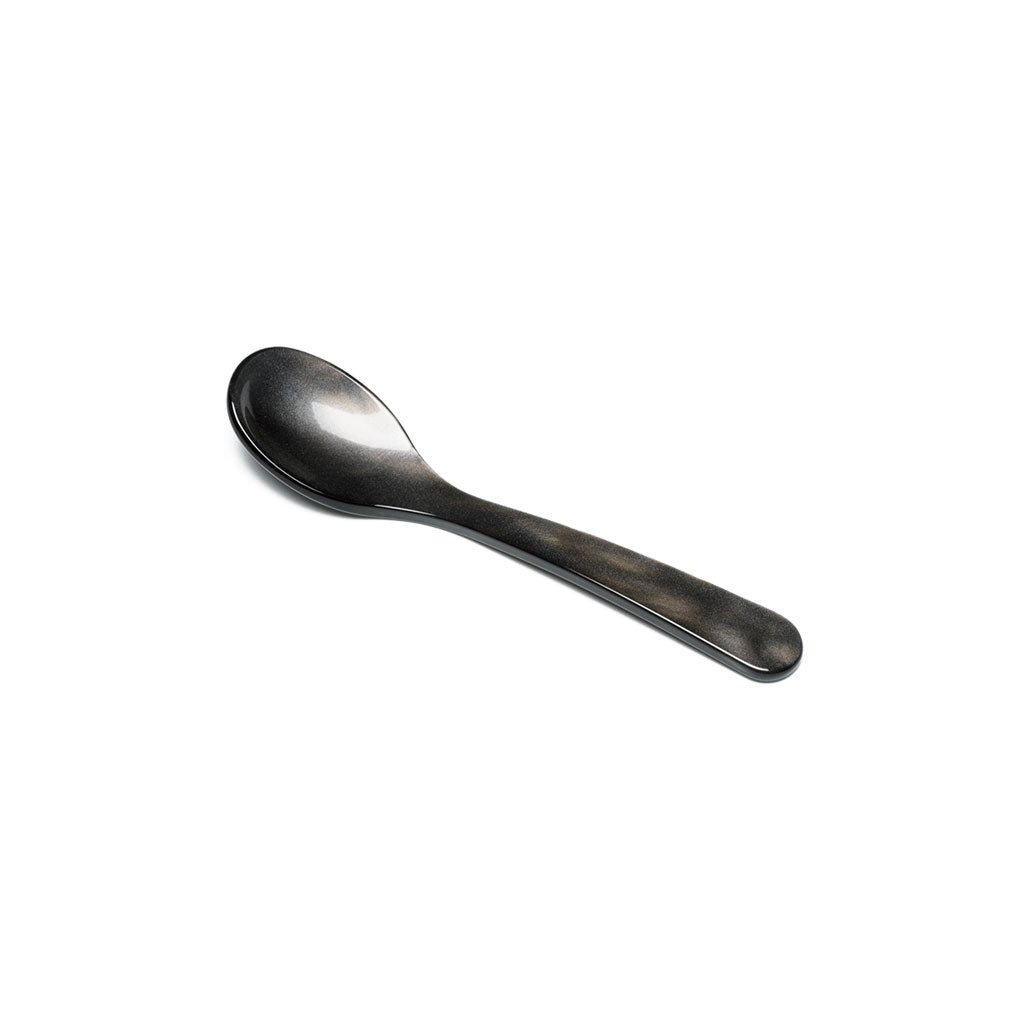 Brownish gray acrylic egg spoon on white background