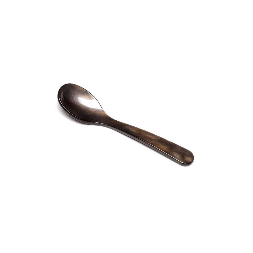 Brown acrylic egg spoon on white background
