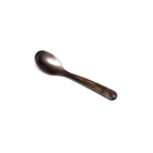 Brown acrylic egg spoon on white background