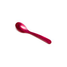 Raspberry pink acrylic egg spoon on white background