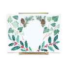 An open card with illustrations in front of a kraft paper envelope.