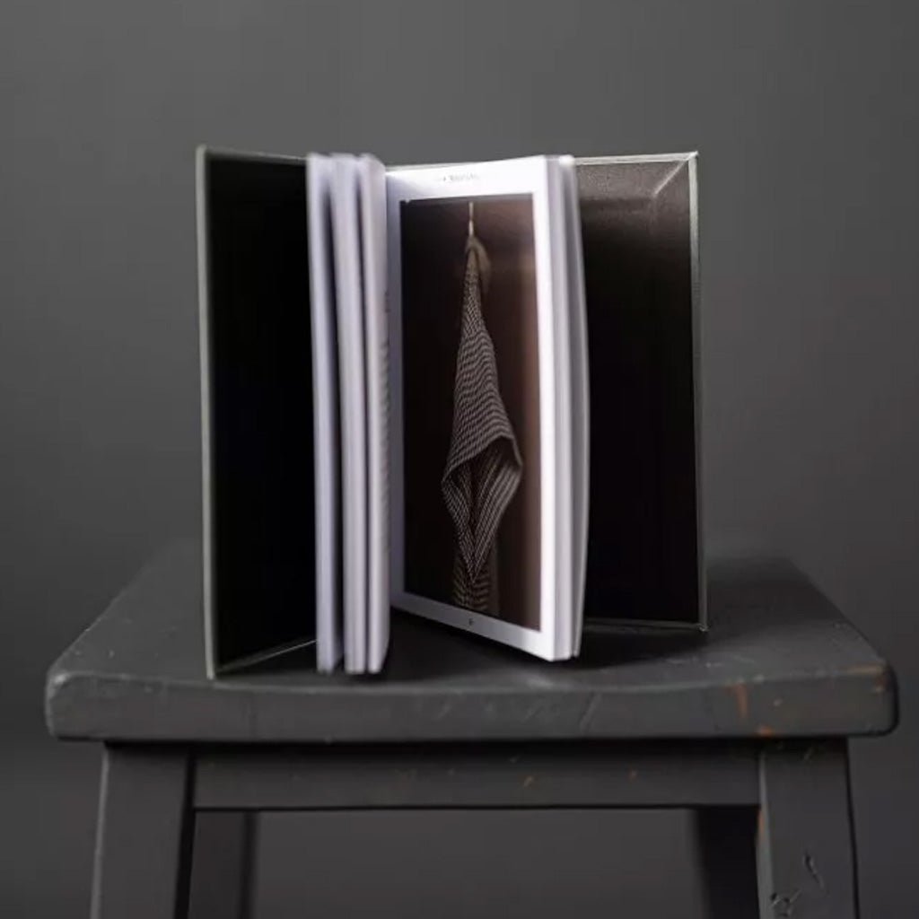 Merchant and Mills Elementary Sewing Skills Book on gray stool on gray background