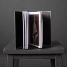 Merchant and Mills Elementary Sewing Skills Book on gray stool on gray background