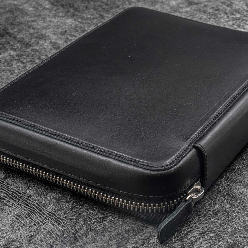 Black leather folio zippered pouch on white background