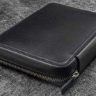 Black leather folio zippered pouch on white background